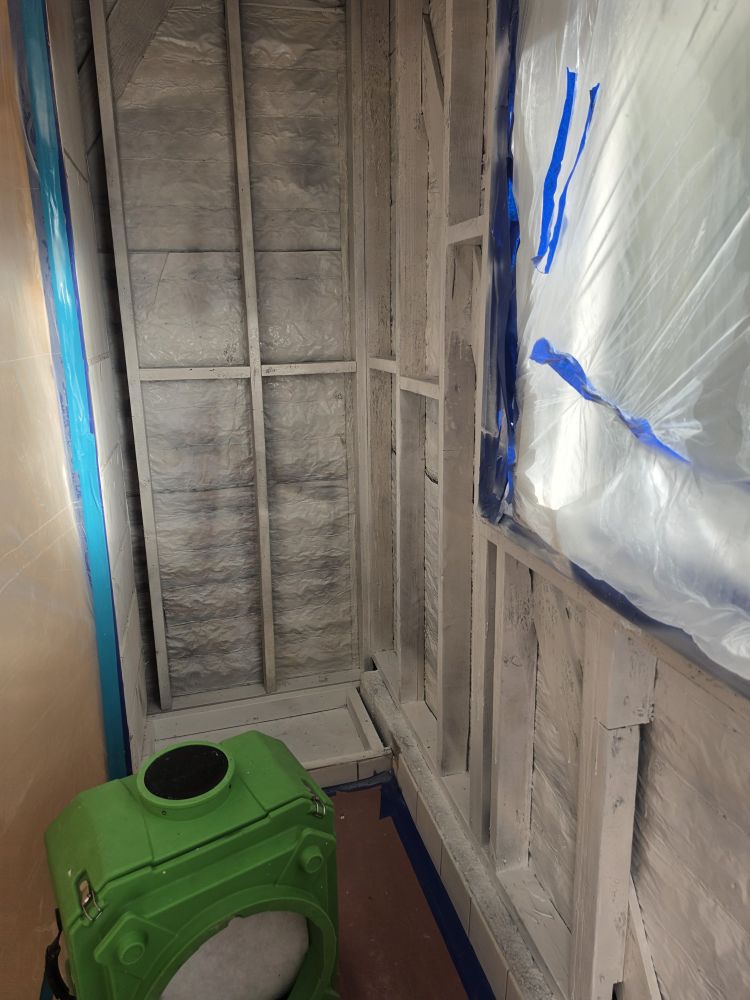 Plastic sheeting containment sealing off a mold work area
